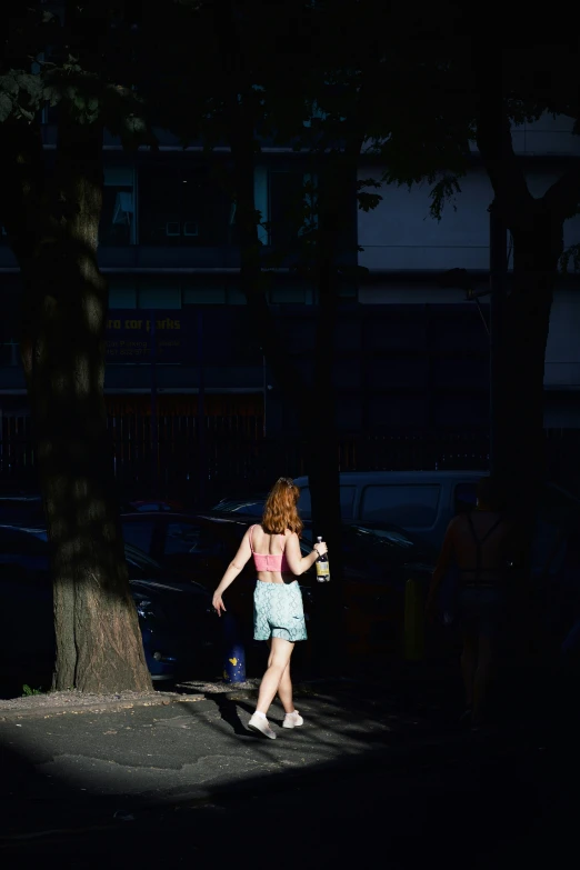 a person in blue dress walking through the street