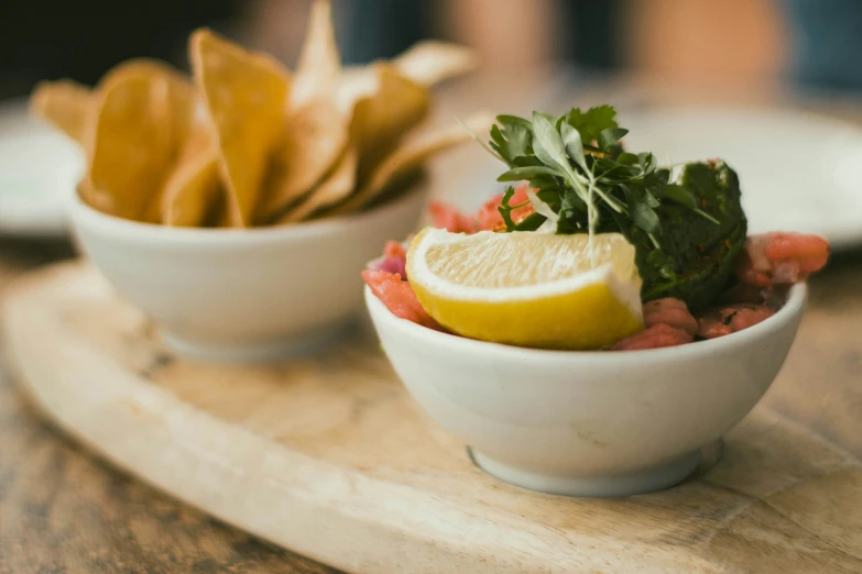 a small white bowl of food is sitting on a plate