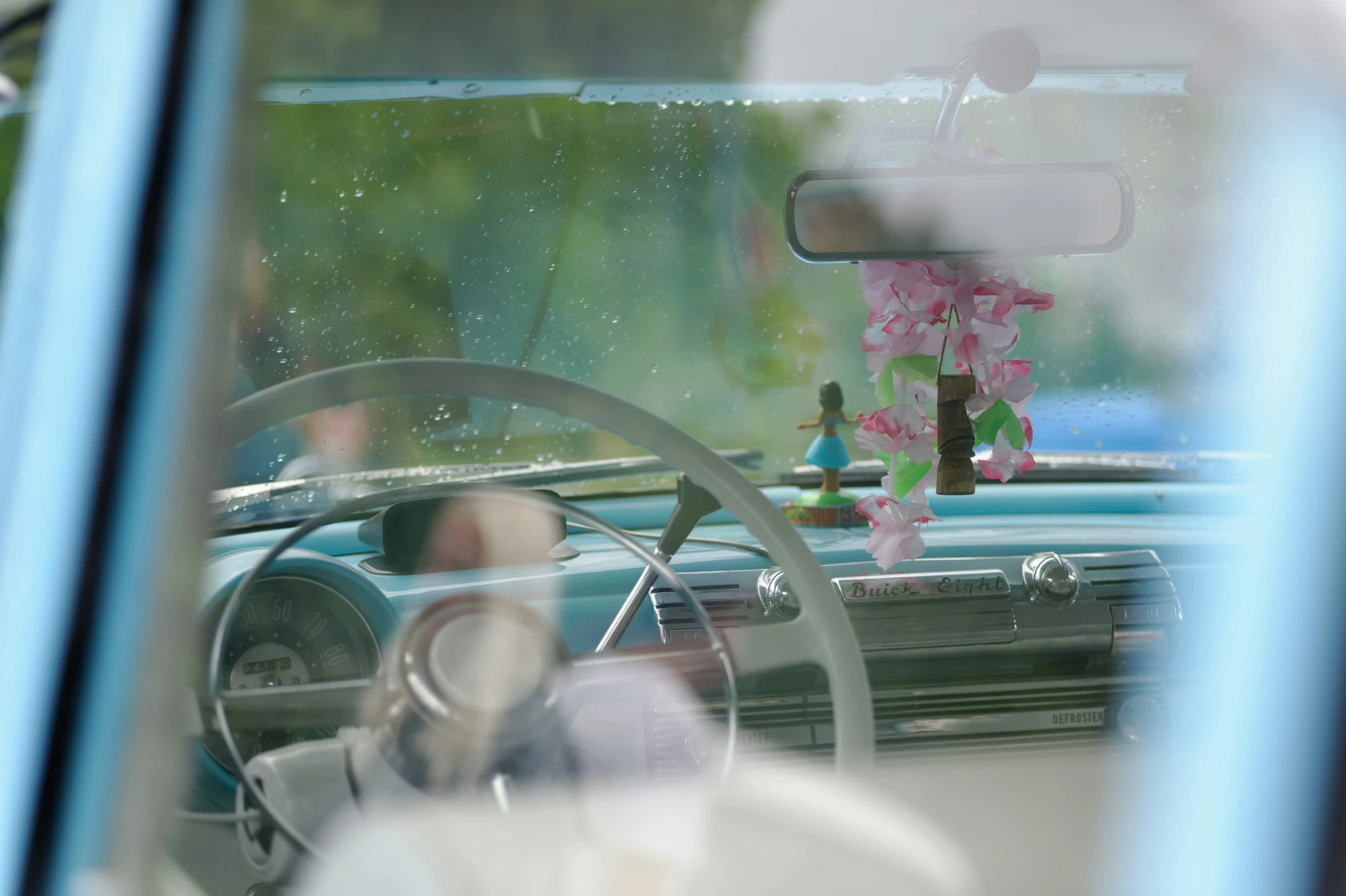 the inside of an old car seen through the windscreen