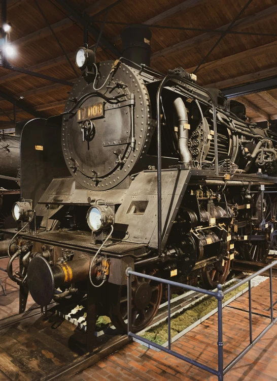 old train on display at museum with bright lights