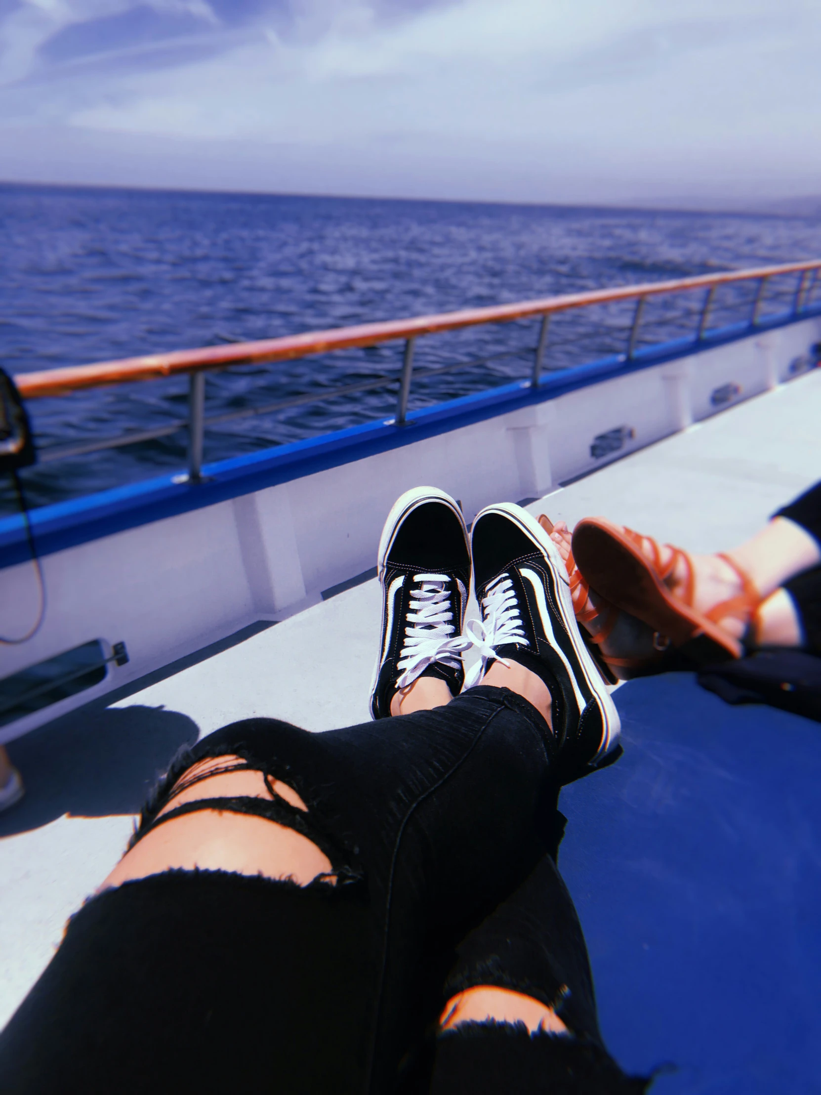 someone's feet on the deck of a boat