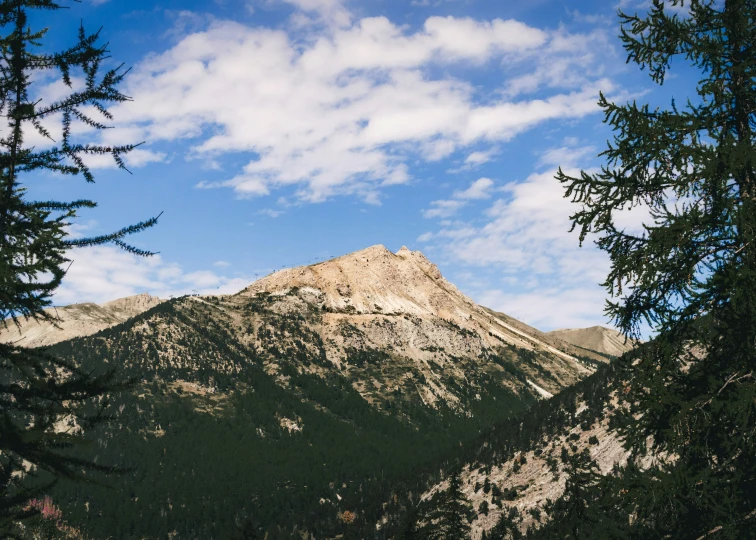 a high mountain in the distance with a sky background