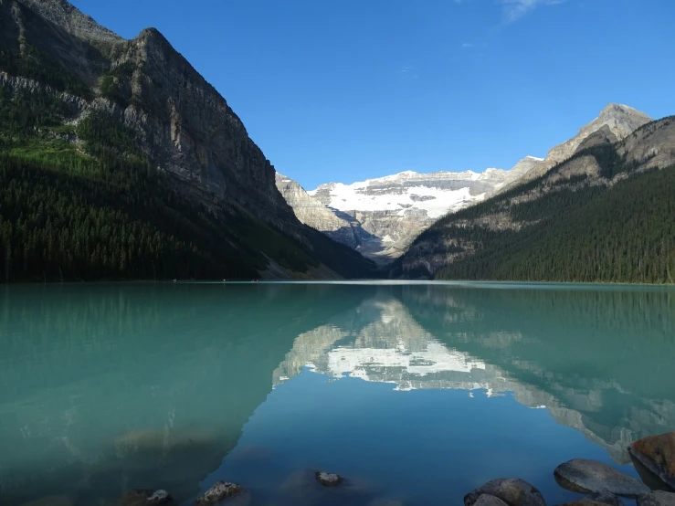 a lake surrounded by mountains and rocks