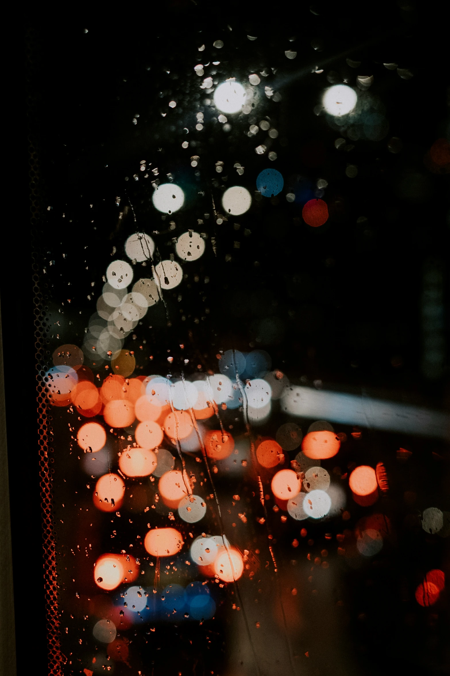 night traffic are blurred and viewed through a window