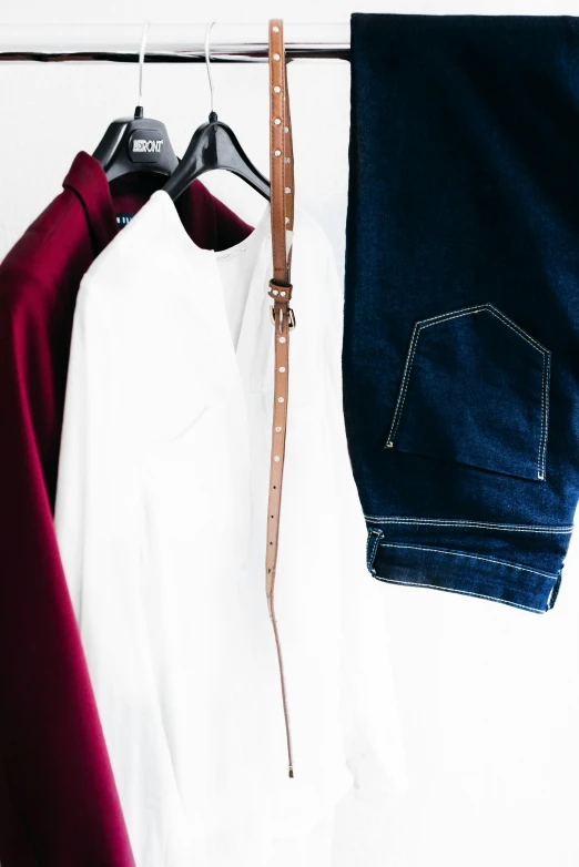 some pants hanging on the clothes line and a pair of brown and white shoes