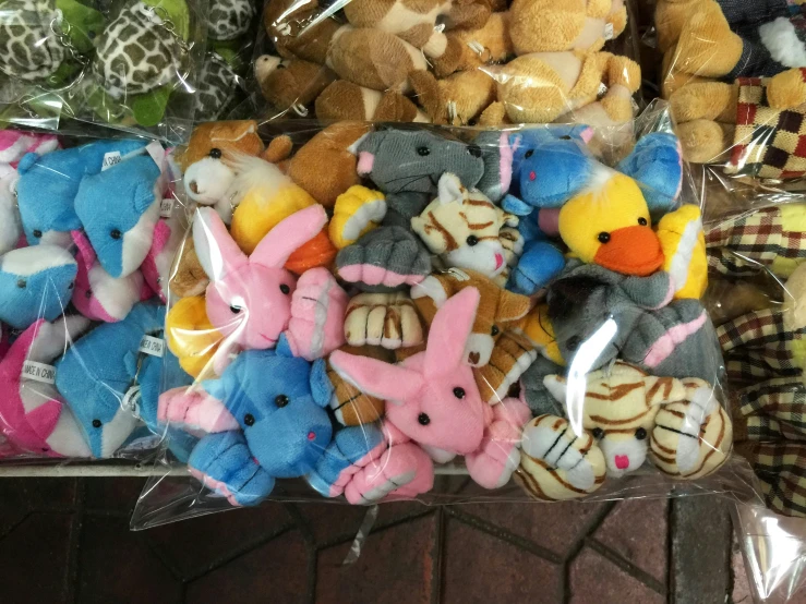 a bunch of stuffed animals sitting together in a basket