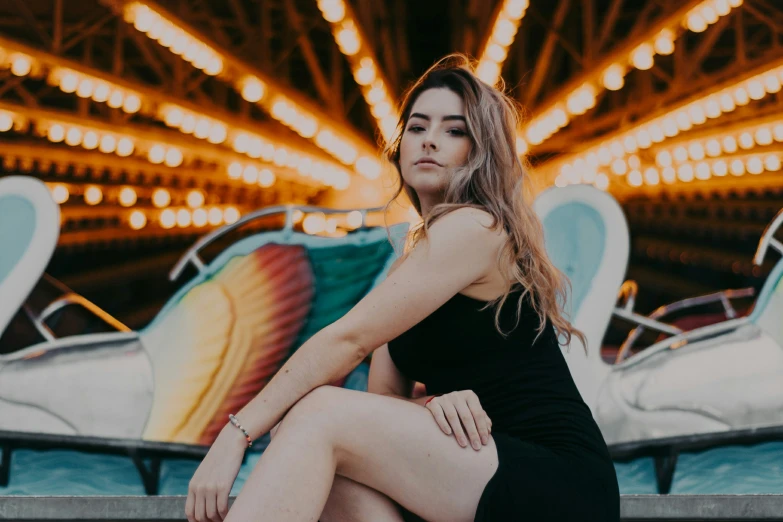 woman sitting on a bench in front of an amut park