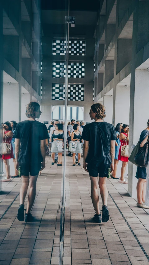 people stand in the middle of a hallway