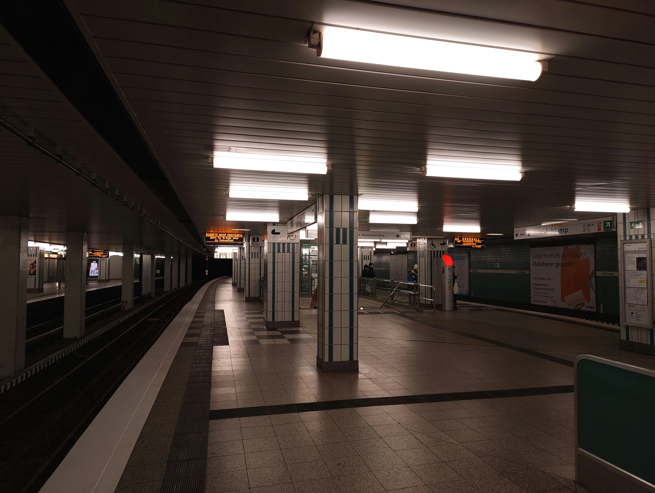 a train station with a train approaching the station