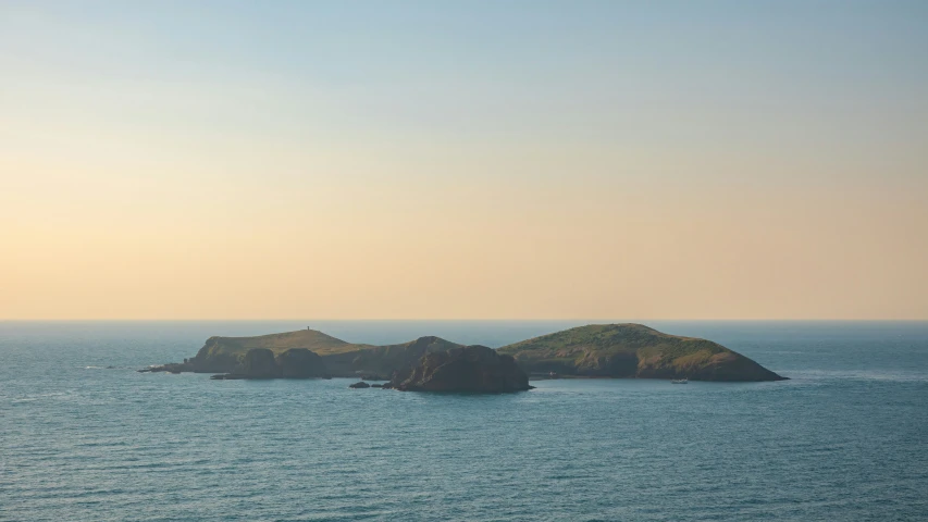 three island sitting in the middle of the ocean