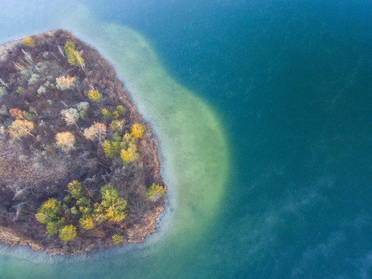 an island in the middle of blue water