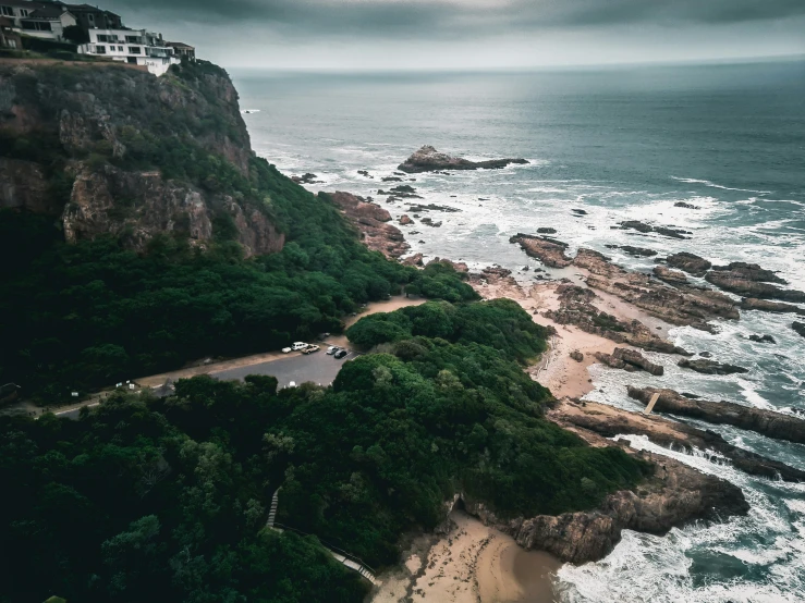 a scenic beach along the coast with a lighthouse