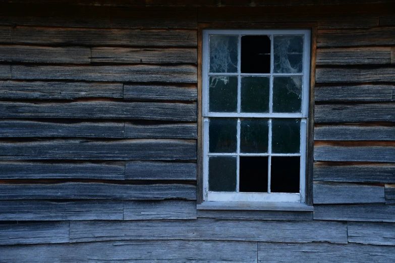 a window sitting on the side of a wood building