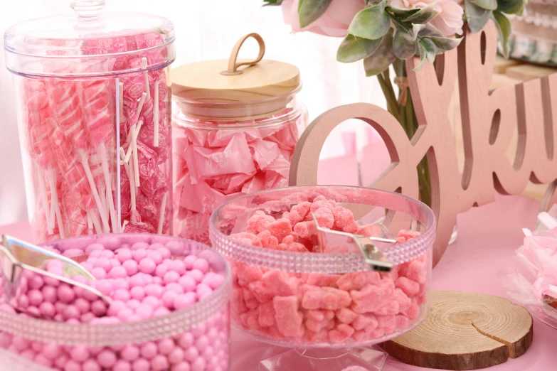 a table topped with pink and white candies