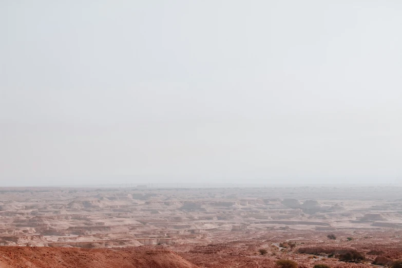 the lone man stands in the open barren area