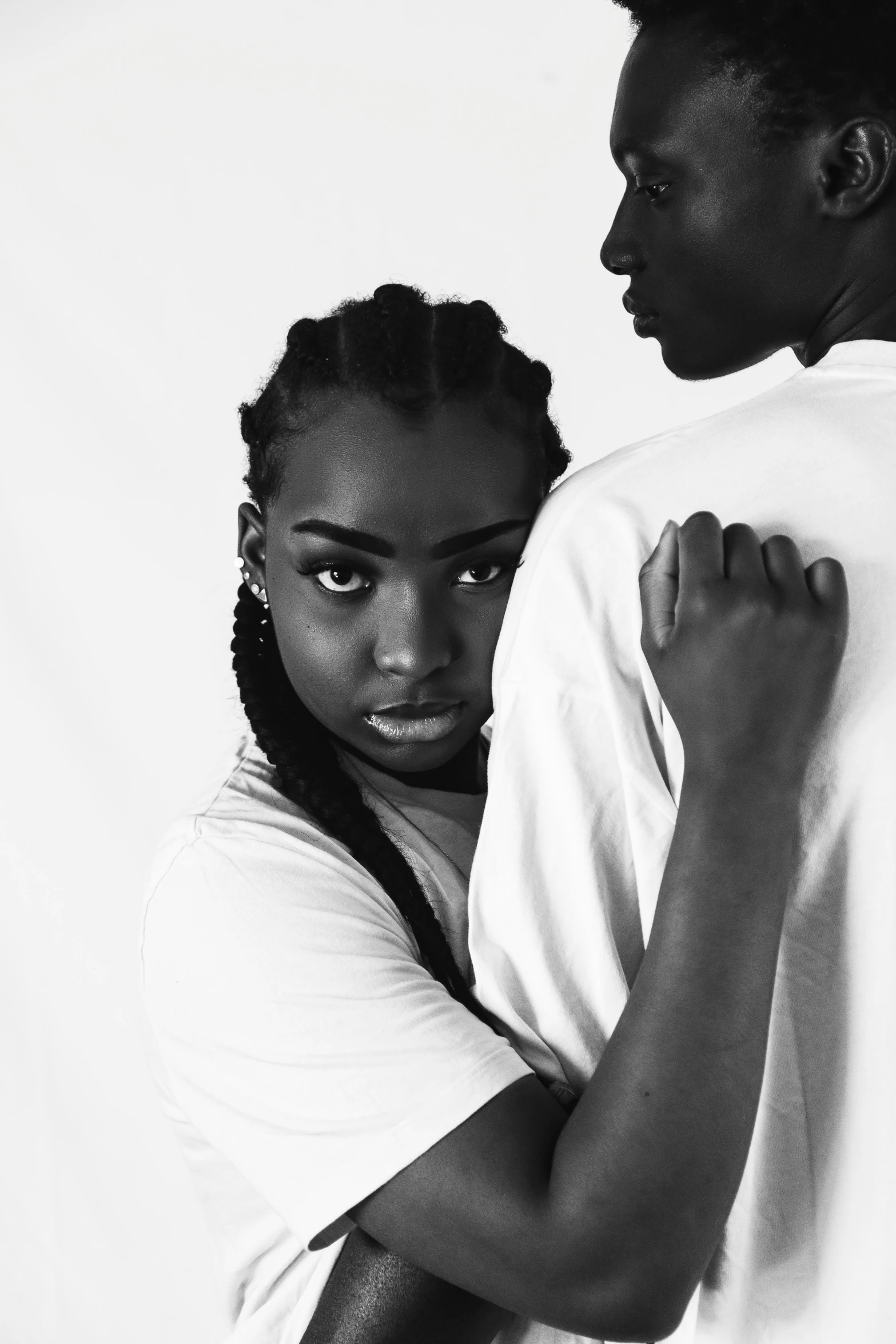 a young man emcing his young lady in black and white