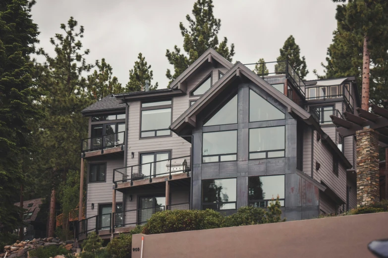 a home with many windows in a forest