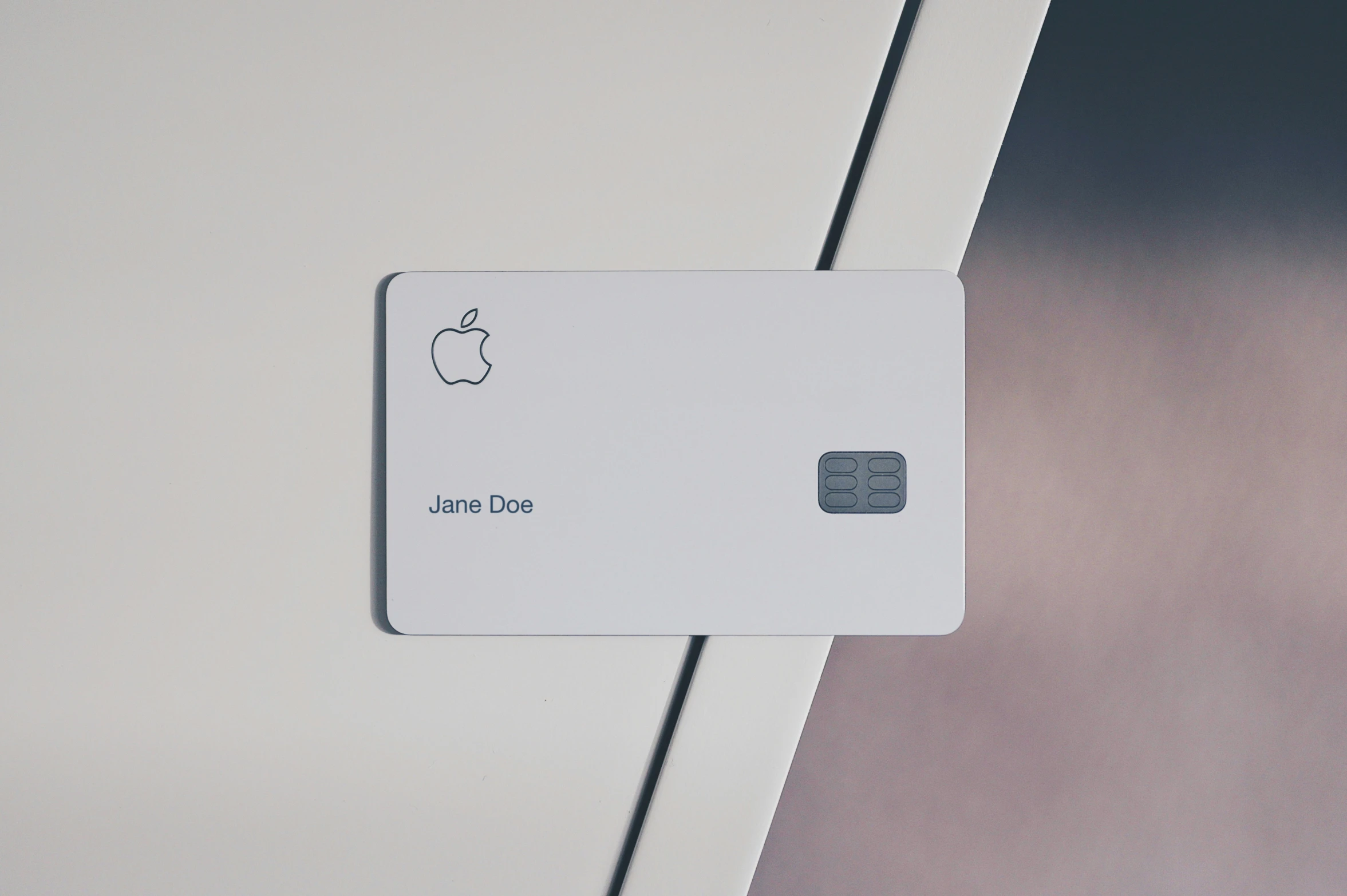 an apple credit card is being held up to the wall