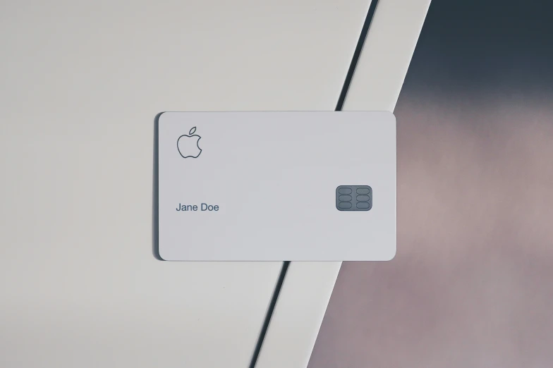 an apple credit card is being held up to the wall