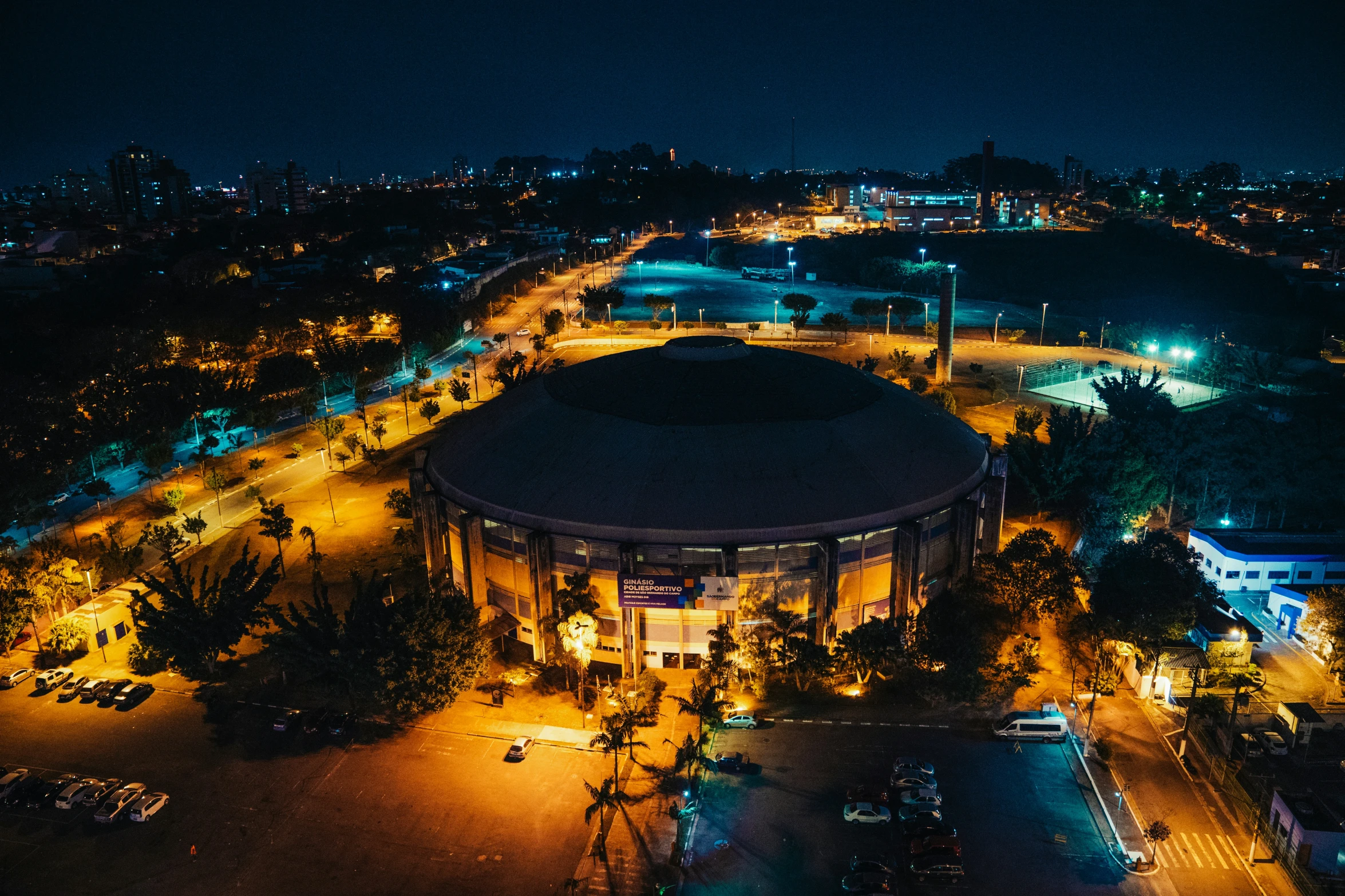 a picture of a city at night with lights on and the building in the middle