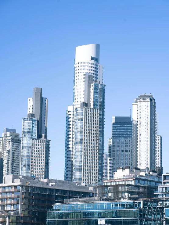 a city skyline with many tall buildings, some have balconies