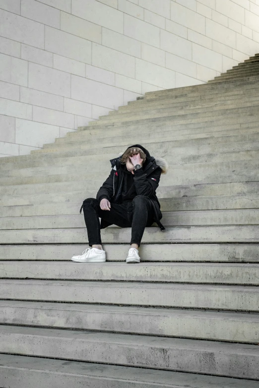 a woman sitting on a set of stairs