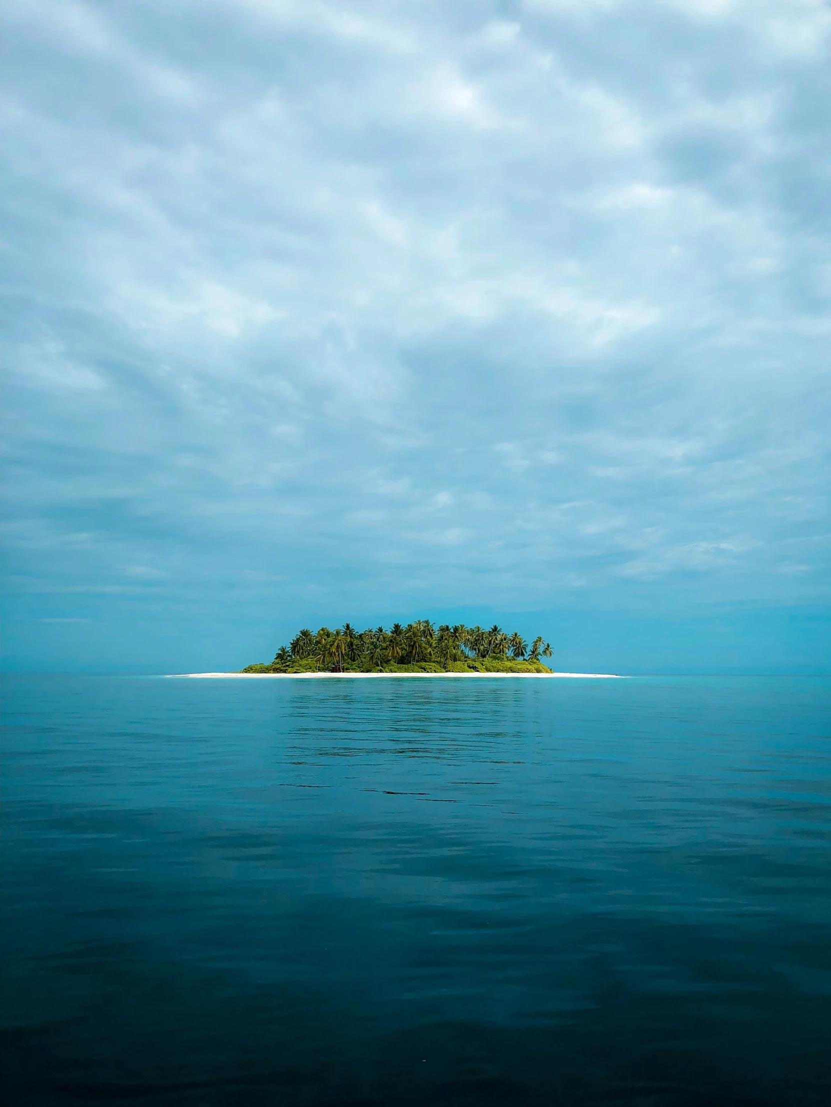 the small island is located alone in the blue ocean