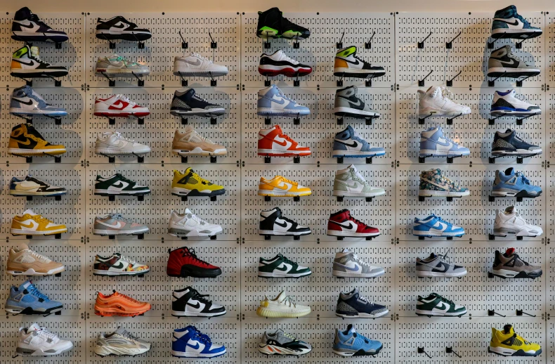 a bunch of different sneakers that are on a pegboard