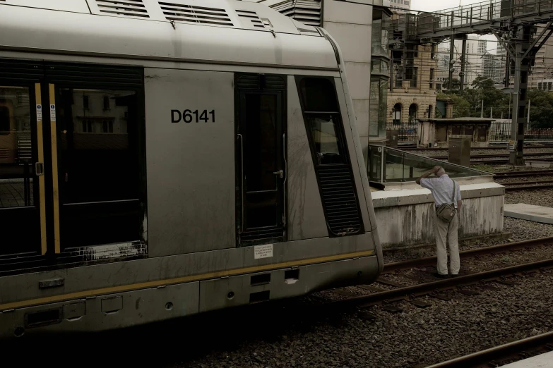 a train car sitting next to an old railroad station