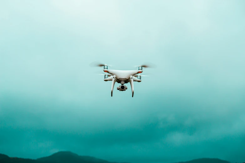 a white airplane with one propellor flying through the air