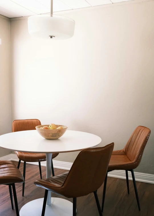 a room with three chairs that are next to the table