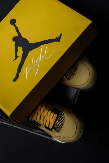 a box that has a pair of yellow shoes inside of it