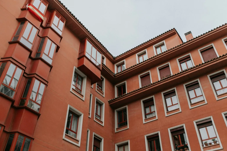 red buildings with balconies and some windows