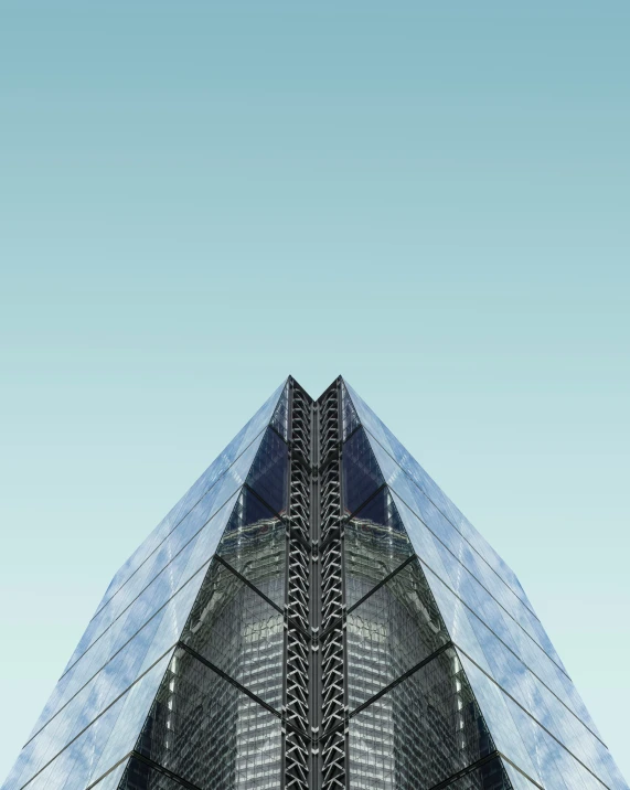 a tall triangular building with lots of windows