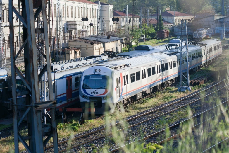 a train is parked near many buildings on the tracks