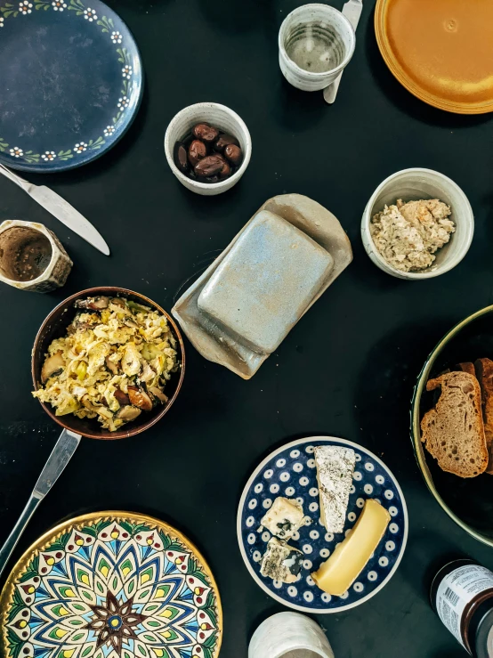 many plates of food lay on a table