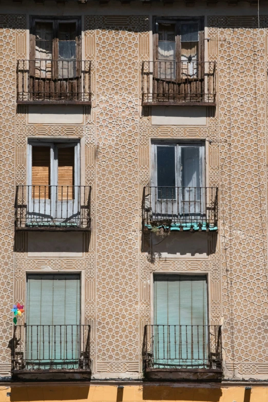 the building has many windows and balcony balconies