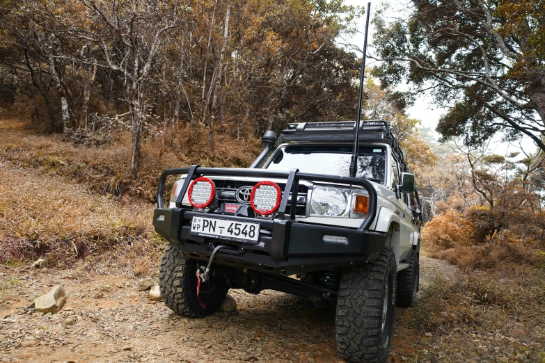 the front end of a four door suv in a trail