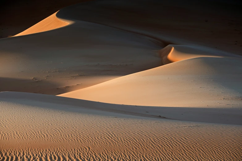 the sun is shining on sand dunes