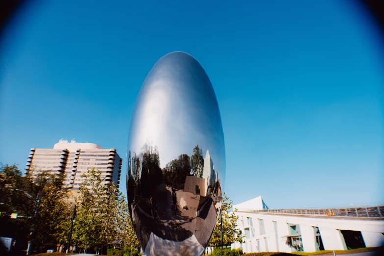 a bird statue is featured against a blue sky