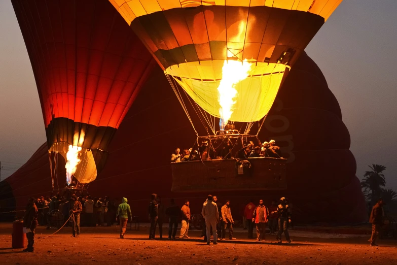 several large  air balloons lit up at night