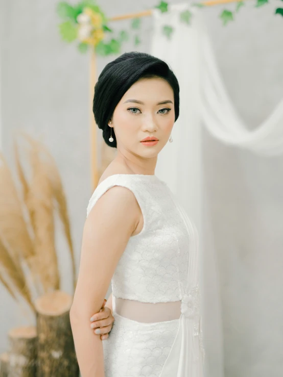 a woman is posing in her wedding dress for a pograph