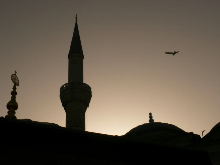 an airplane flying over the top of an old building