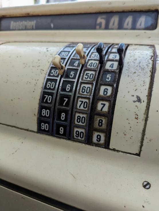 a dirty and rusty machine with multiple numbers and numbers