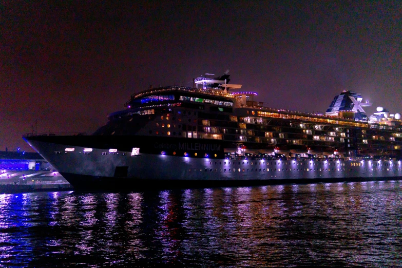 a large cruise ship at night in the water