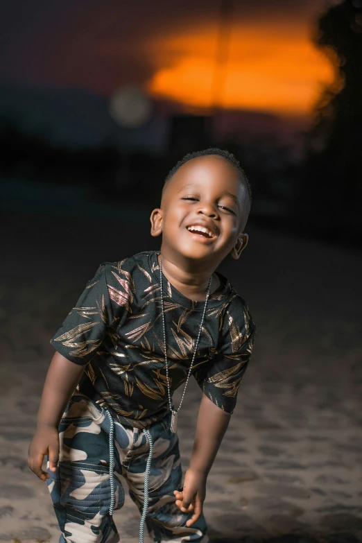 a child is laughing and standing on a beach