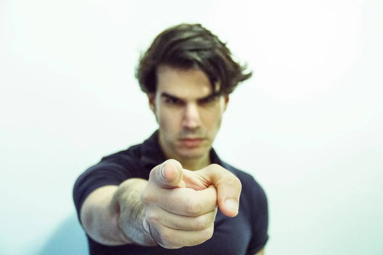 a man with a black shirt pointing at soing