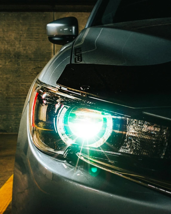 the lights on a silver car in a parking garage