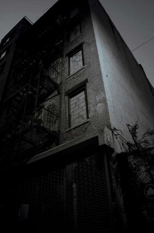 the front view of a building at night, it is black and white