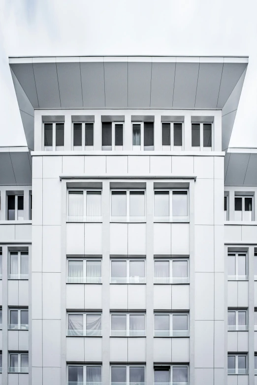 the facade of a building with windows and a sky background